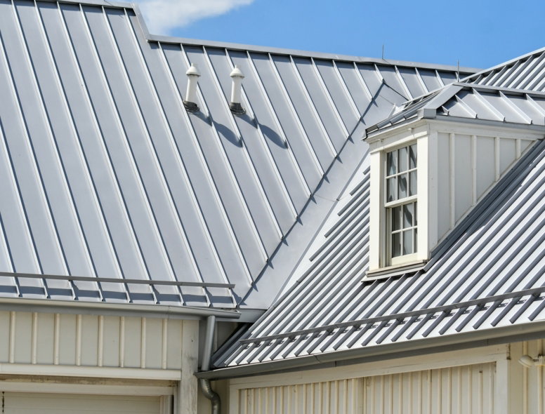 grey-metal-roof--white-siding--and-a-dormer-window-.jpg Grey metal roof, white siding, and a dormer window.